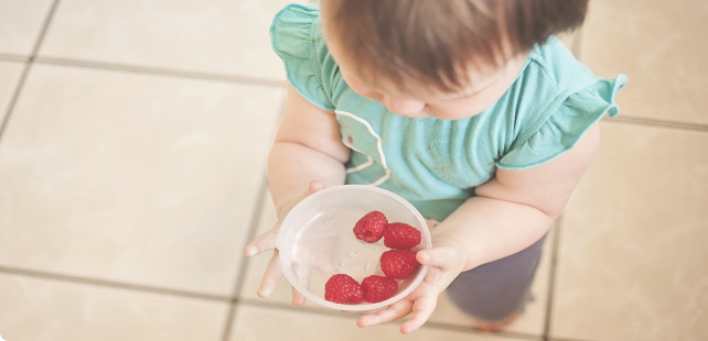 Child sharing berries