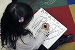 young student draws on paper
