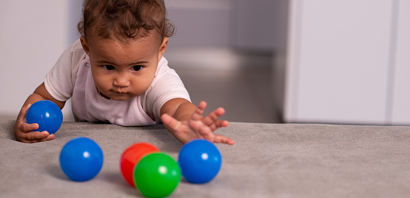 Baby playing with plastic balls